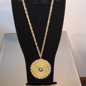 Gold-tone Neck with a 2" Textures Medallion Accented with Sparkling Stones